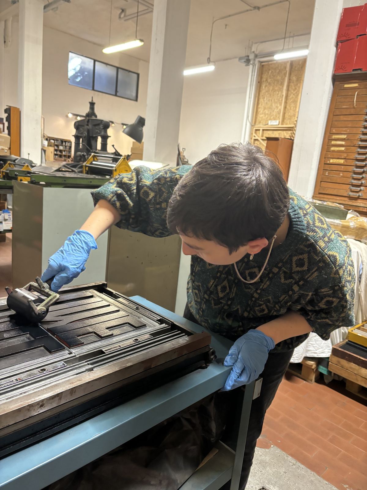 Angie inking a letterpress forme during the Full of Time workshop